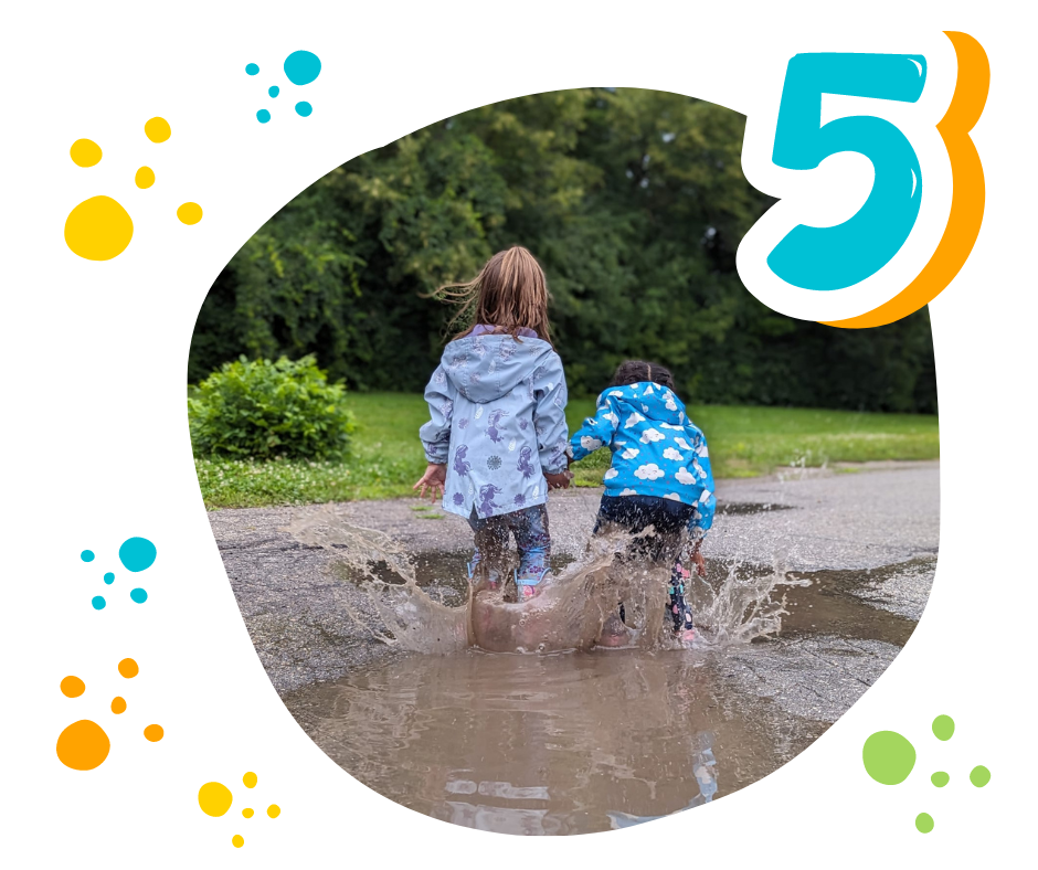 two children jumping and splashing in puddles