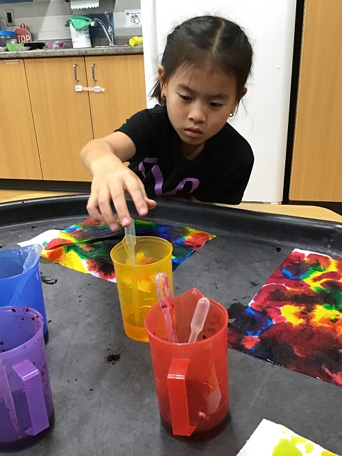 School age child participating in an art experience 