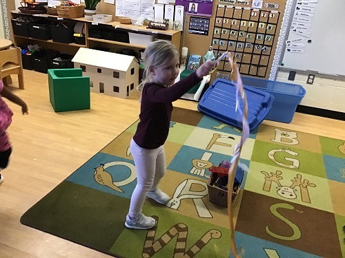 Child dancing with her ribbon