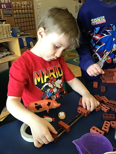 Child making structure with bricks