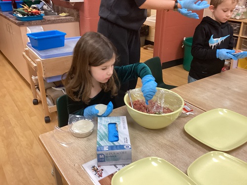 school age girl filling dumpling
