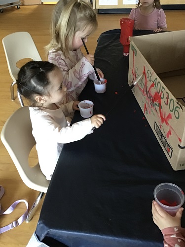Painting the fire truck made from cardboard box