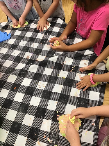 Children at a table playing with cloud dough