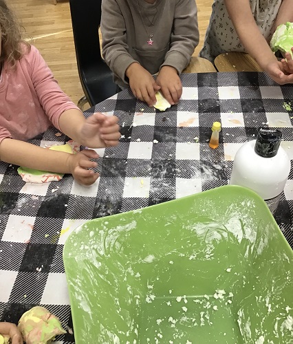 Children at a table playing with cloud dough