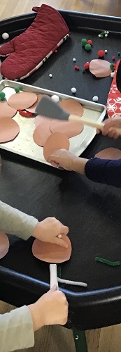 Children playing with the materials on the tuff tray