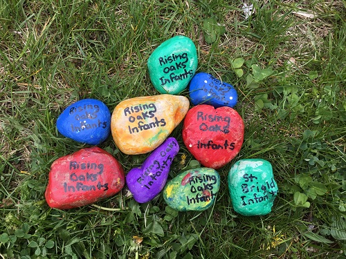 A pile of painted rocks laying in the grass