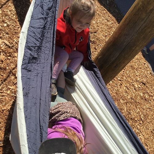 Two children in a hammock outside