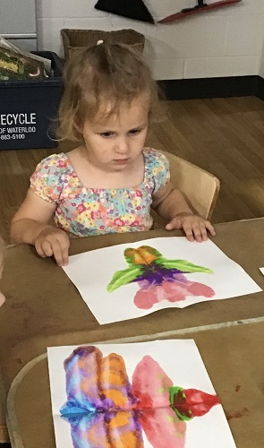 A child painting at a table