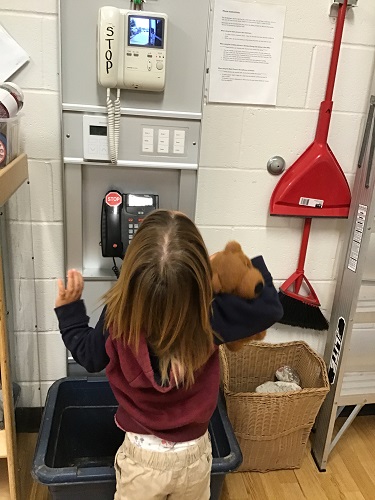 A child standing in front of the doorbell camera, looking up at the screen