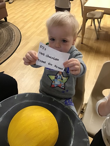 A child showing off his ticket