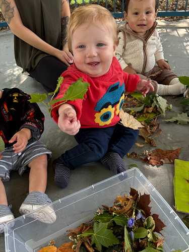 Children sitting in the gazebo using nature items to create artwork