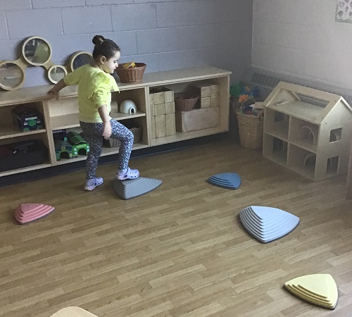 A child using the stepping stones in the classroom