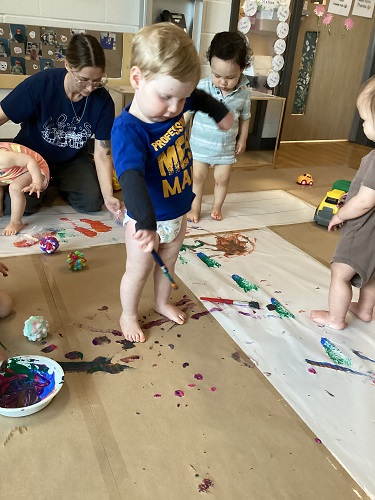 Children painting all over the classroom