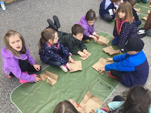 Children outside working on their gifts for Mother's Day
