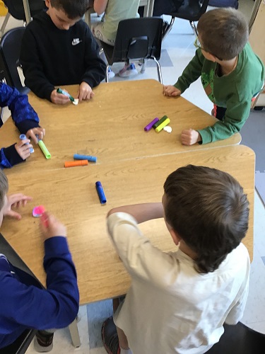 Children working on a craft at the table