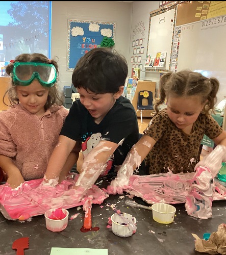 Children exploring with shaving cream and food colouring