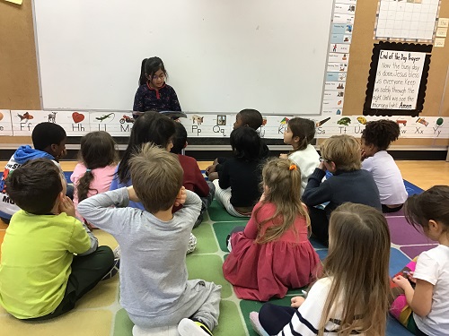 Child reading to the class