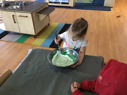 child mixing the slime