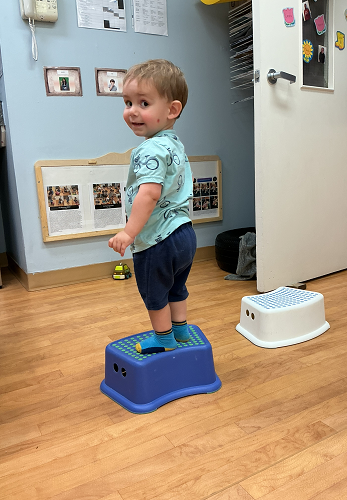 child climbs stool
