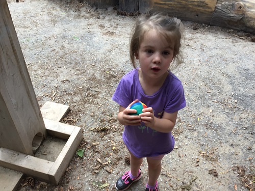 child holds ball