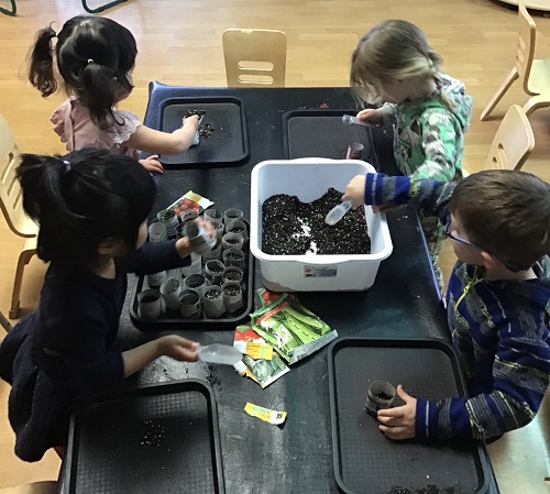 Children creating planter pots