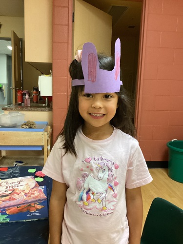 school-age girl made bunny ears