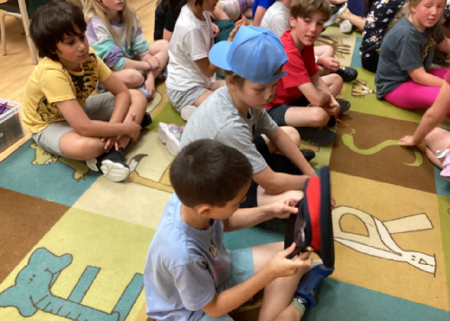 school-age children studying officer hat