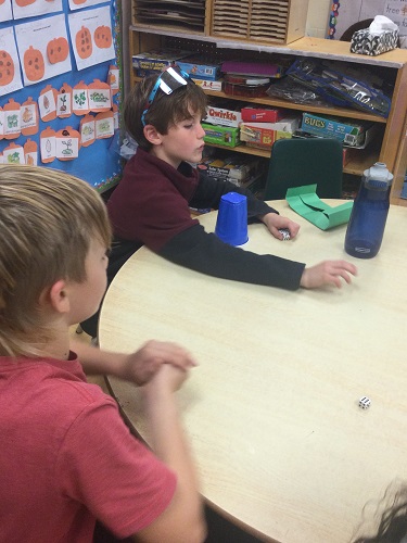 two boys playing dice game 