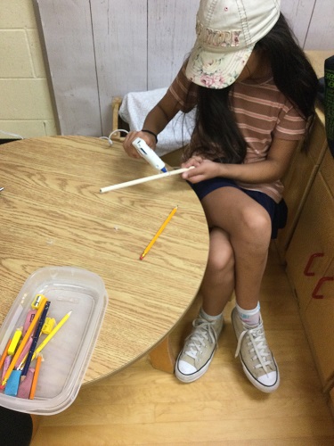 school-age girl creating design on her wand