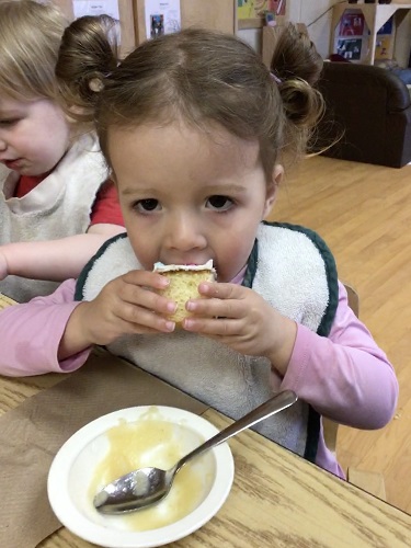 Toddler girl eating cake 