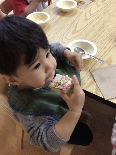 Toddler boy eating cake