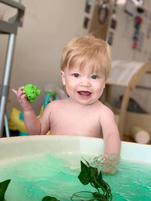 A child exploring with the green water provocation.