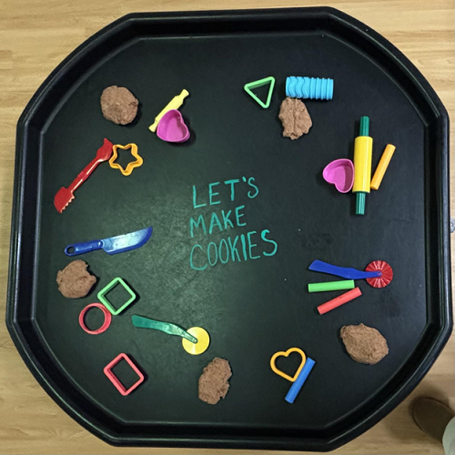 A cookie themed playdough tuff-tray provocation.