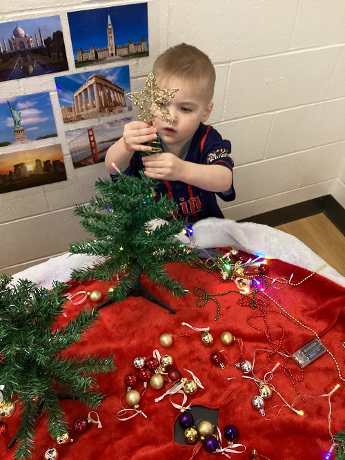 A child decorating their tree.