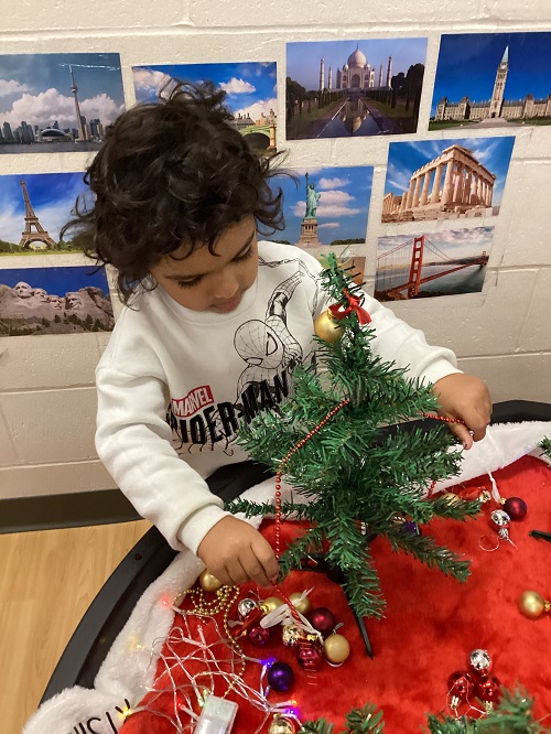 A child decorating their tree.