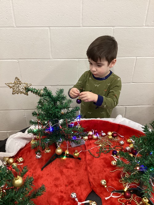 A child decorating their tree.