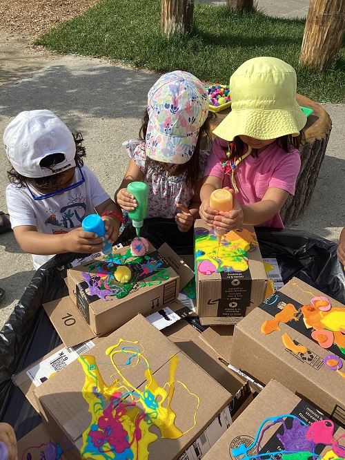 Children exploring with coloured glue