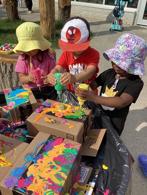 Children exploring with coloured glue