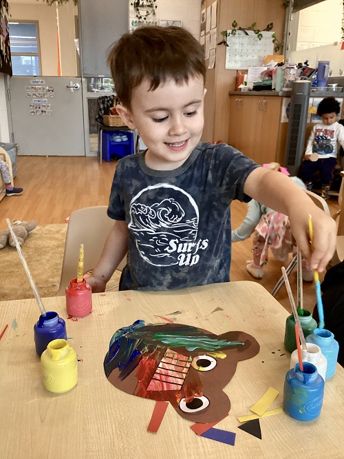 A child working on their artistic creation.