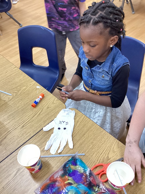 A child looking down at their bunny creation.