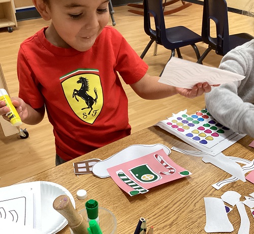 A child working on their artistic creation.