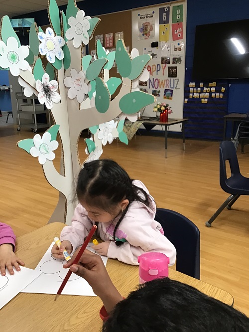 A child drawing and colouring a flower.
