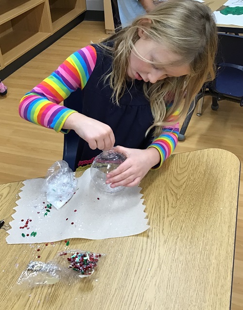 A child creating their tree ornament.