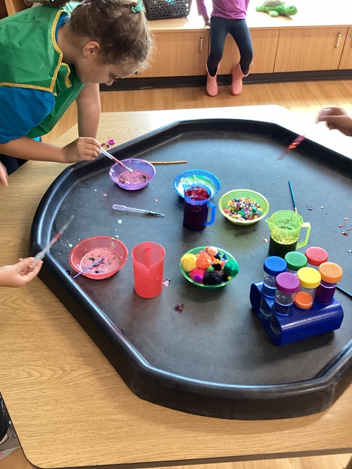 Children engaging in an artistic and scientific experience.