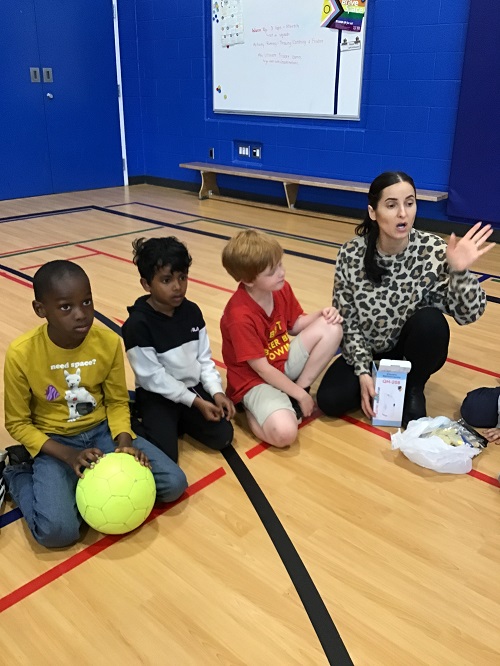 An educator facilitating a discussion with the group of children.