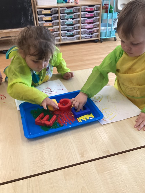 Children painting with letters.