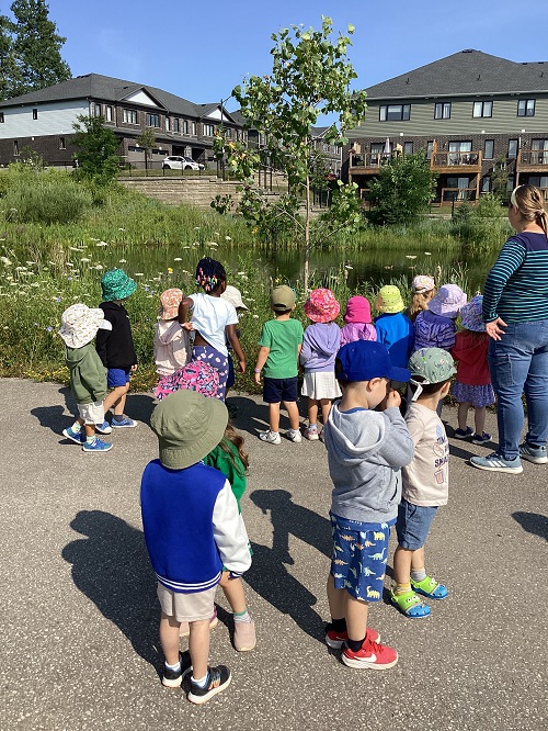 Preschool children looking at a pond