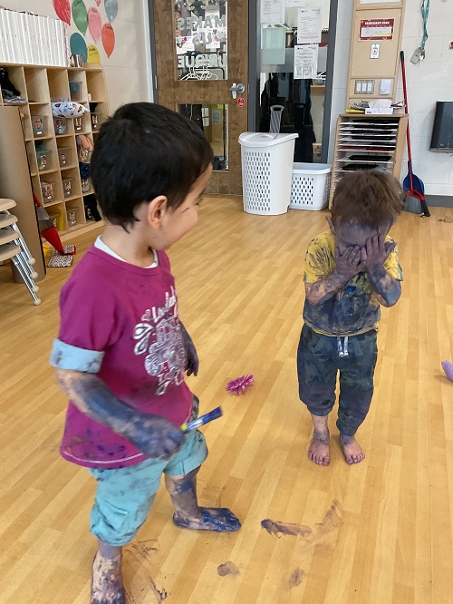 2 children covered in paint