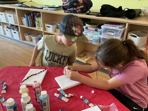2 children with acrylic paint