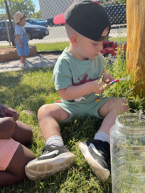 child cutting grass